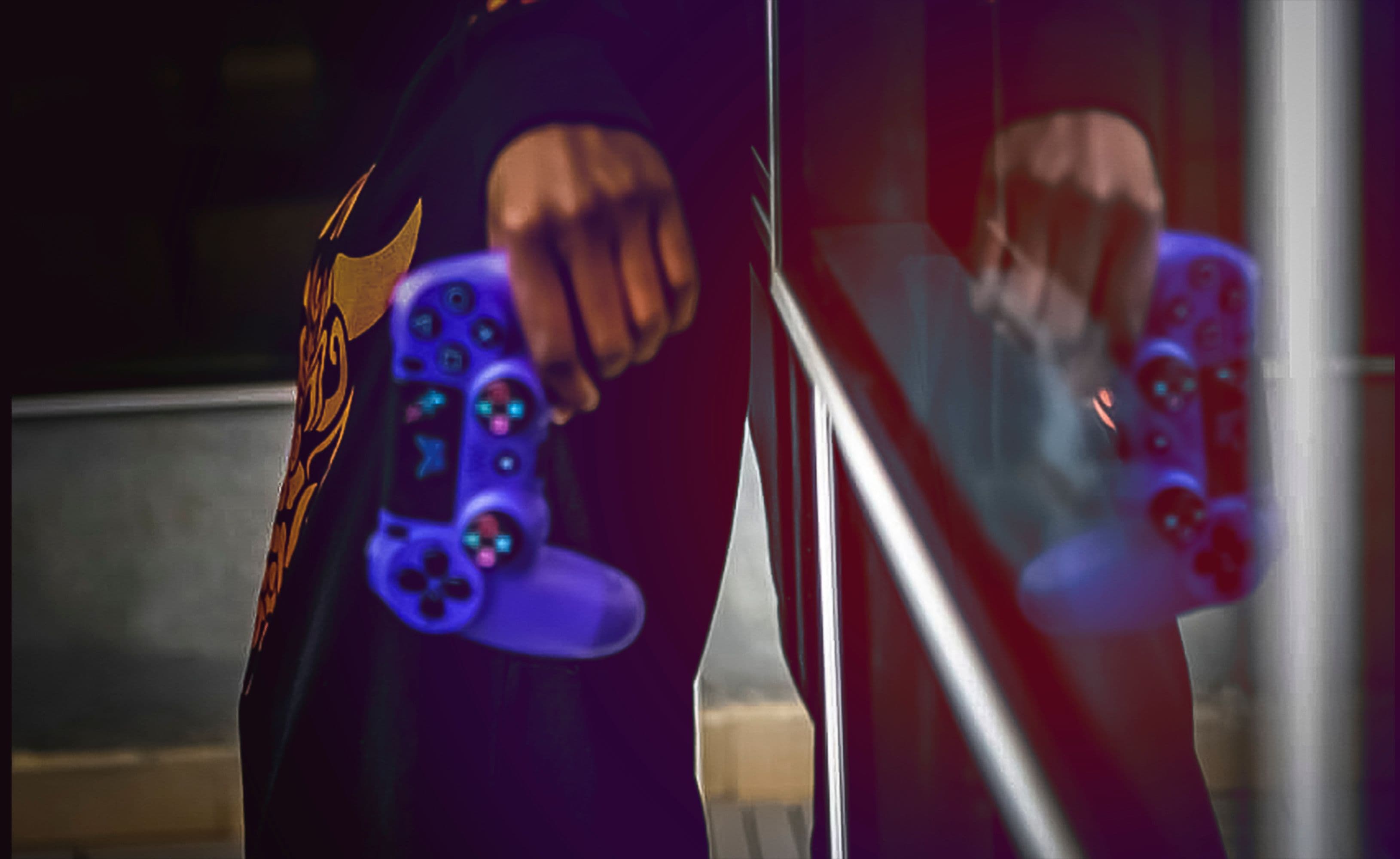 An image of a person holding a blue gaming control pad