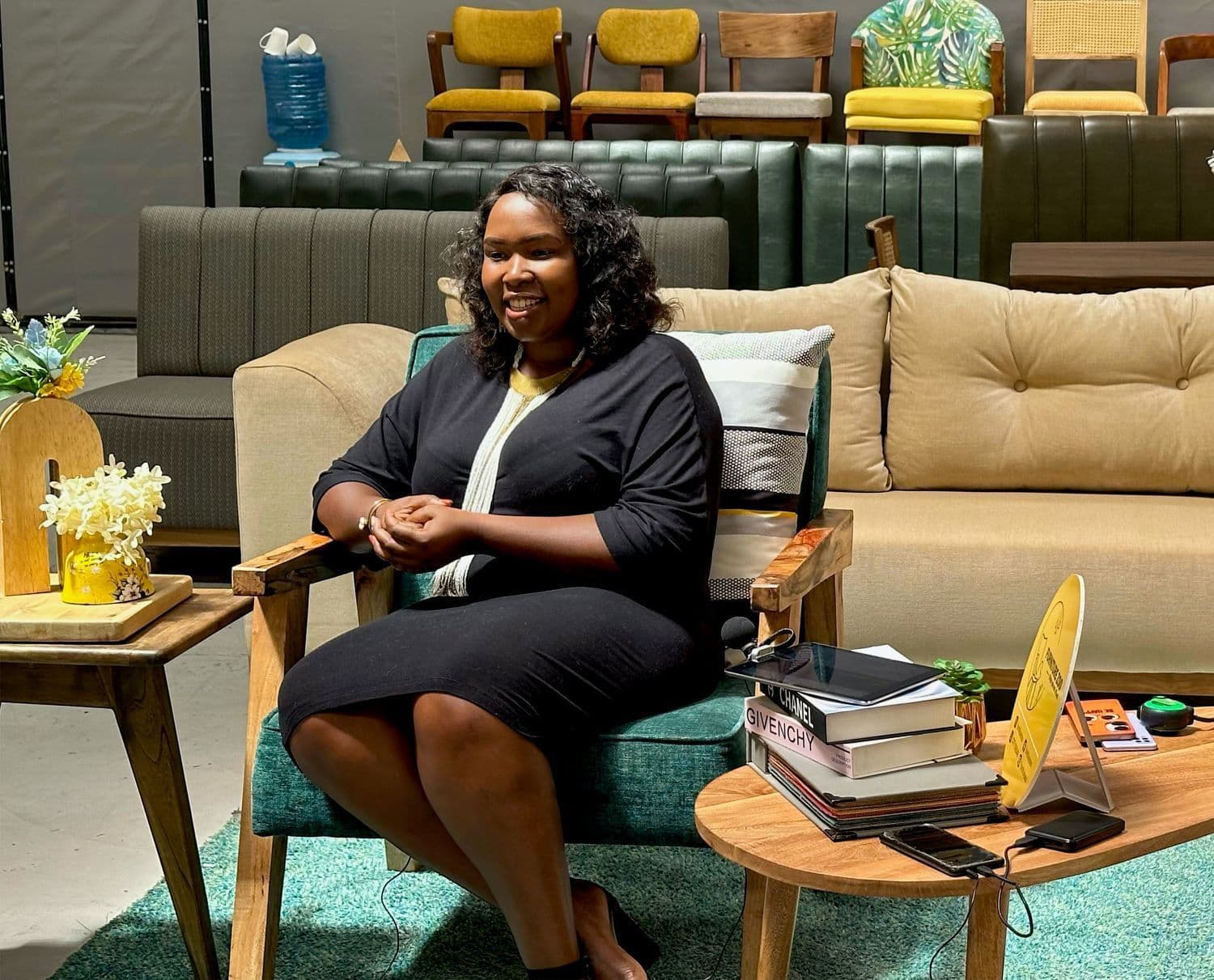 Emily Wangui posing for a photo in the showroom of Furniture Zoo in Nairobi, Kenya